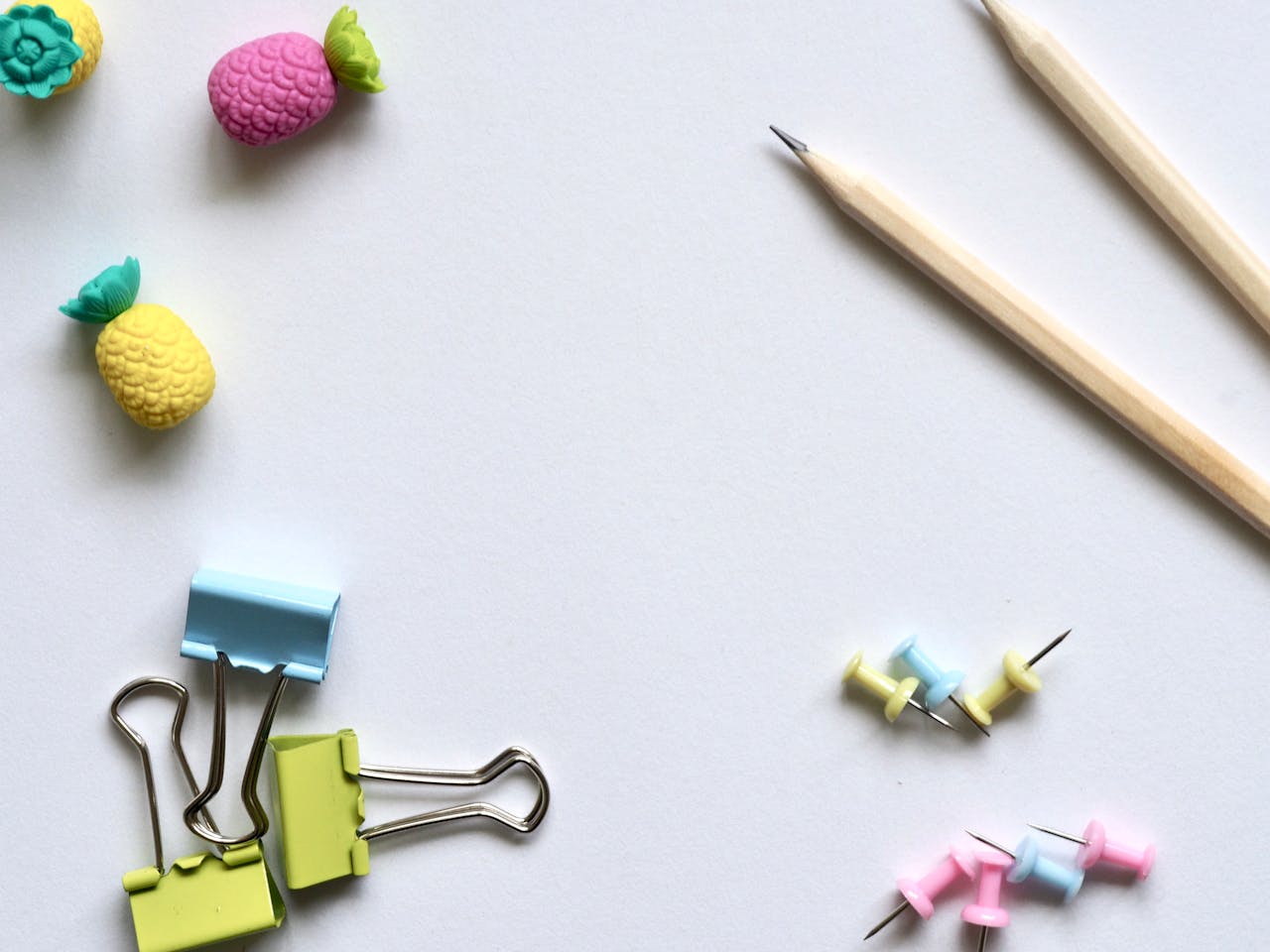 our-story Flat lay of vibrant stationery on a clean white background for a creative work environment.